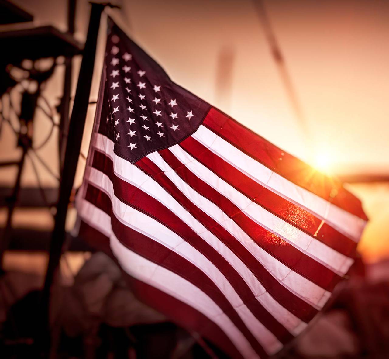 The American flag waving proudly at sunset