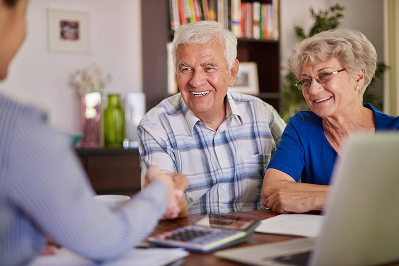 A RoseMark fiduciary advisor reviewing a retirement income plan with an AMAC member couple