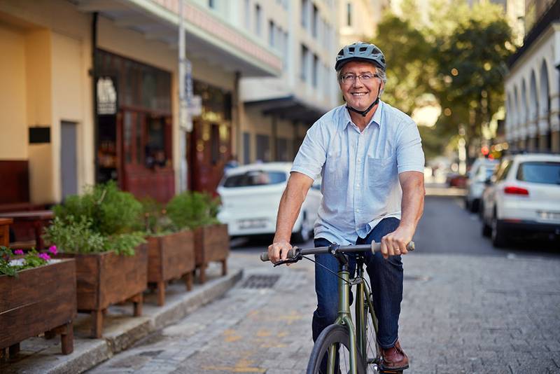 An active early retiree riding a bicycle through the city