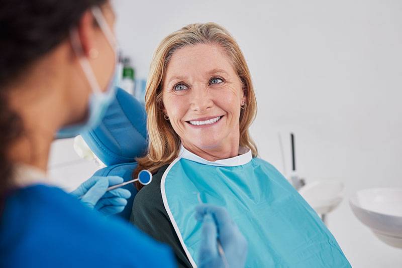 An older woman at a routine dental cleaning