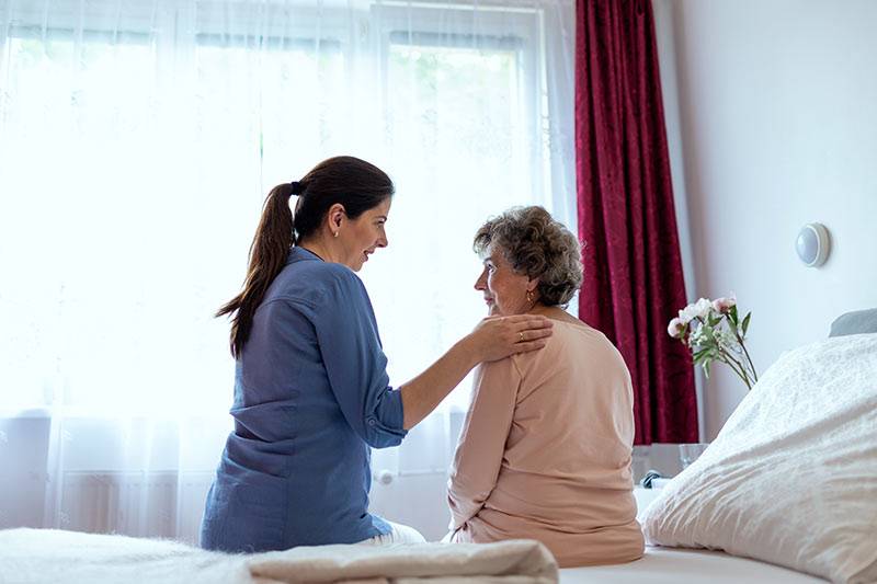 An adult child caring for an older parent at home